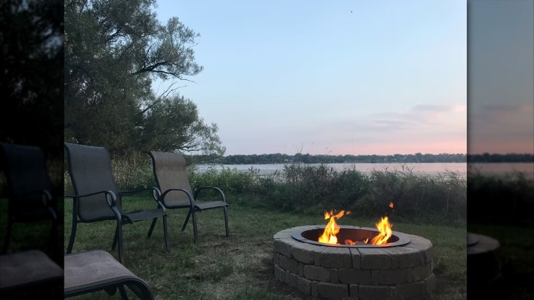 A fire pit overlooking a lake