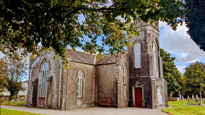 Leaves frame St. Mary's Church and cemetery in Carrigaline, Ireland