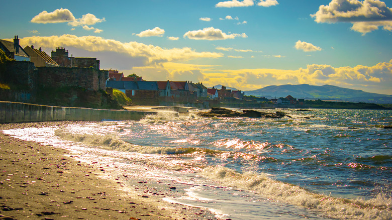 Prestonpans Beach with waves crashing during the magic hour.