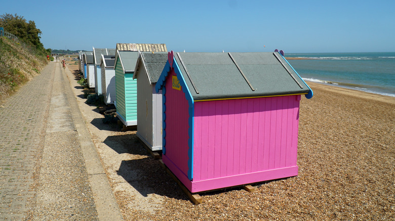 Row of small, colorful beach huts facing the sea in Felixstowe, England