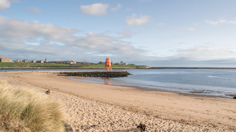 A sandy beach with a lighthouse in South Sheilds