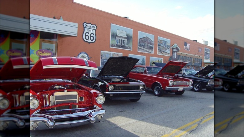 Vintage cars on display at the Bethany 66 Festival, with murals and a Route 66 sign in the background, Bethany, Oklahoma