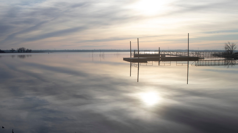 A boat ramp at Stanley Draper Lake, Oklahoma City, Oklahoma, with soft sunlight perfectly mirrored on the calm water