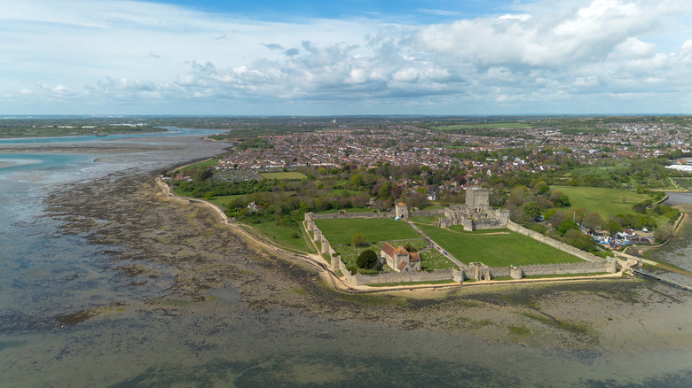 Panoramic view of Portchester Castle surrounded by the coastline and village