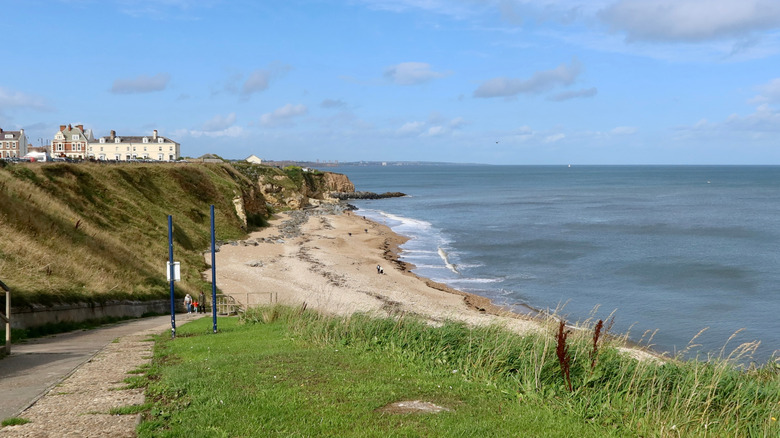 A walking path down to the beach in Seaham, England, on a sunny day