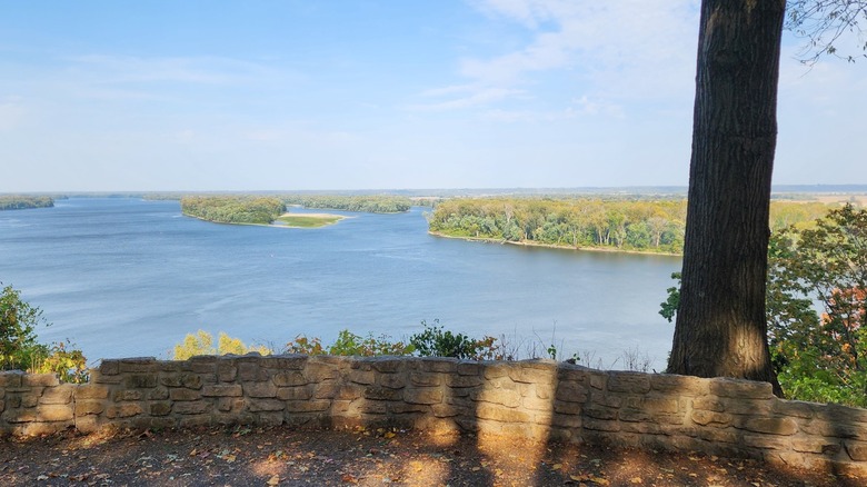 Overlook at Riverview Park, surrounded by a small stone wall and greenery, featuring views of the Mississippi River