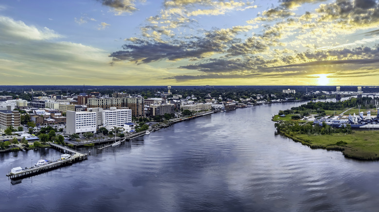 Ariel view of the Wilmington skyline along the river at sunset.