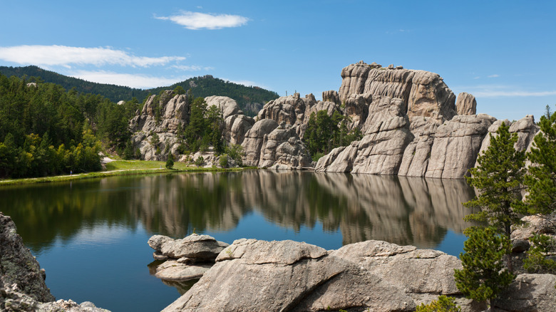 Large rock formations reflected in the still water of Sylvan Lake in Custer State Park