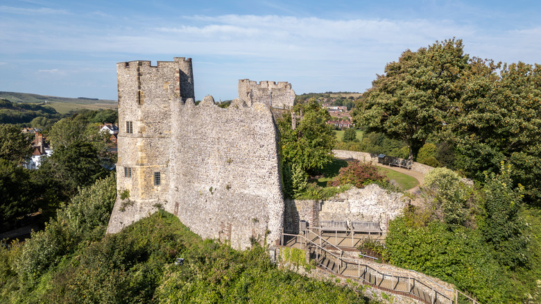 Remains of Lewes Castle rising above a hilltop and surrounding houses and hills in South Downs National Park