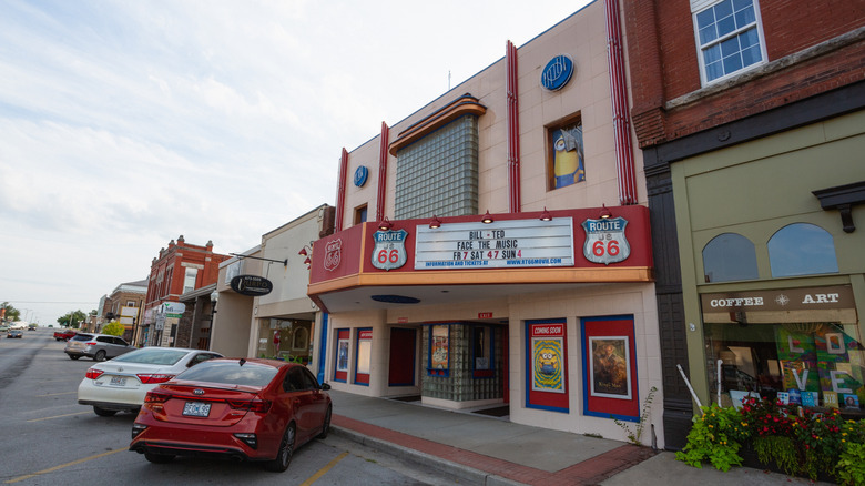 A movie theater with Route 66 road signs above the door in Webb City