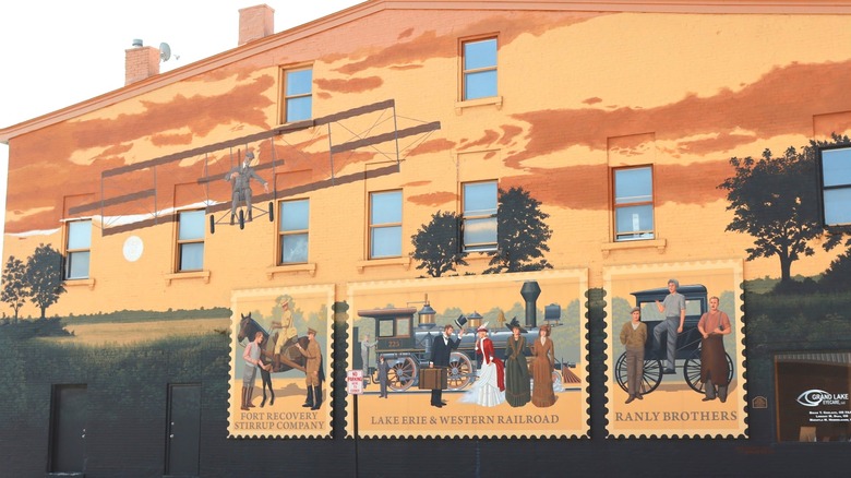 Mural on a building in Fort Recovery, Ohio, showing a biplane flying at sunset
