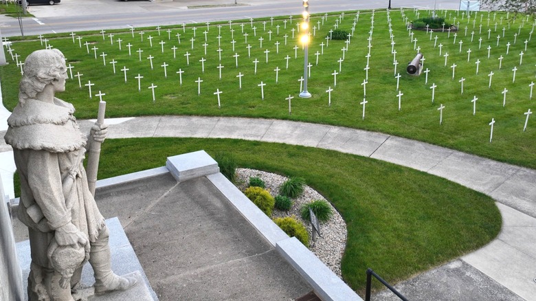 An aerial view of a stone statue and white crosses at the Fort Recovery Monument