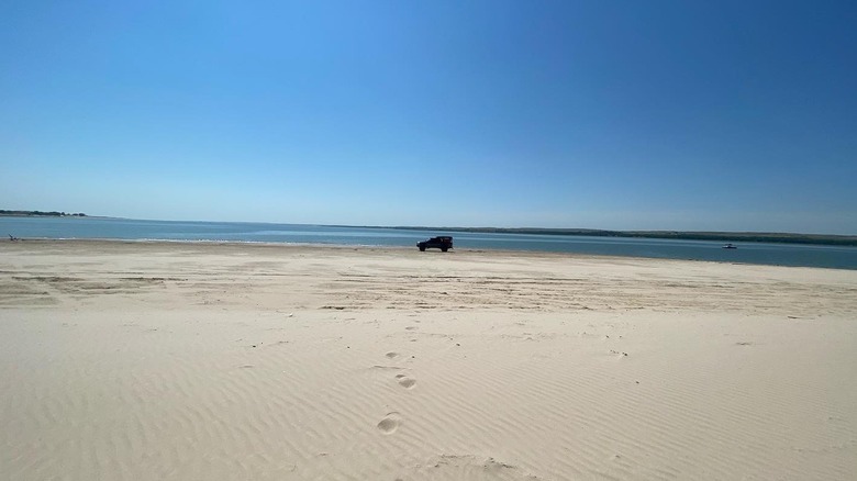 A car parked on a white sand beach at Lake McConaughy, in Nebraska.