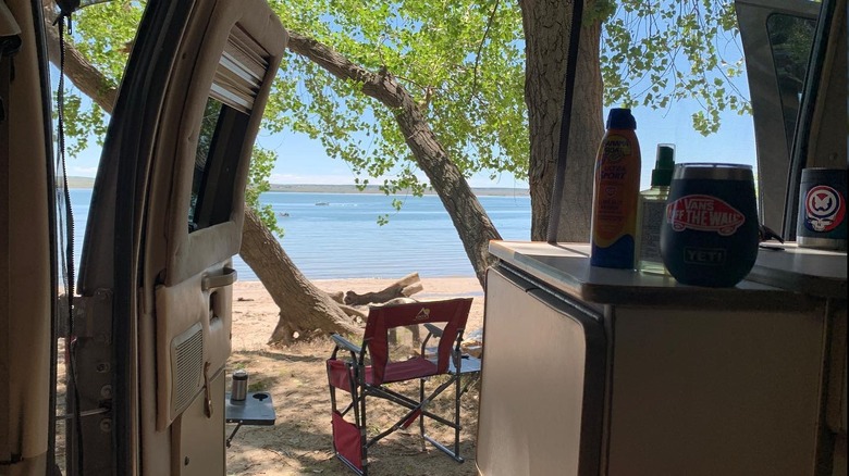 The view from the inside of a camper van looking out the side door at Lake McConaughy.
