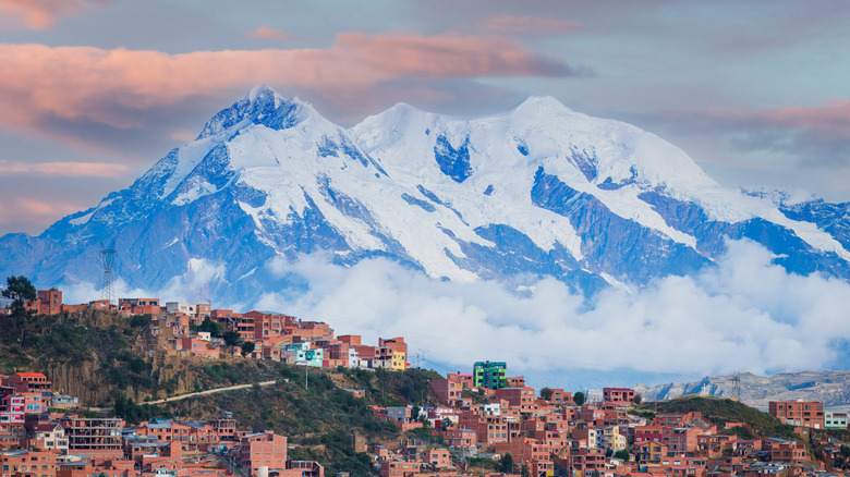 Brown buildings of La Paz, Bolivia, backed by Illimani