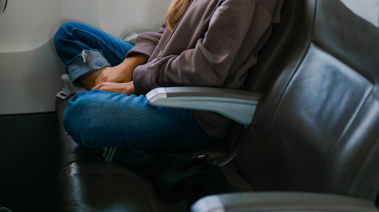 A woman meditates on a flight