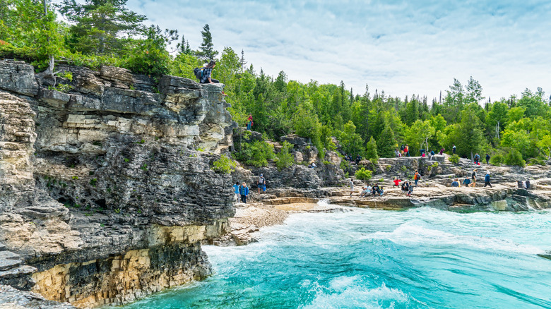 Visitors explore the limestone cliffs of Bruce Peninsula National Park in Ontario, Canada.