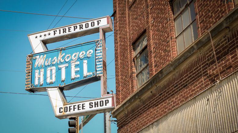 Vintage blue sign outside abandoned hotel in Muskogee