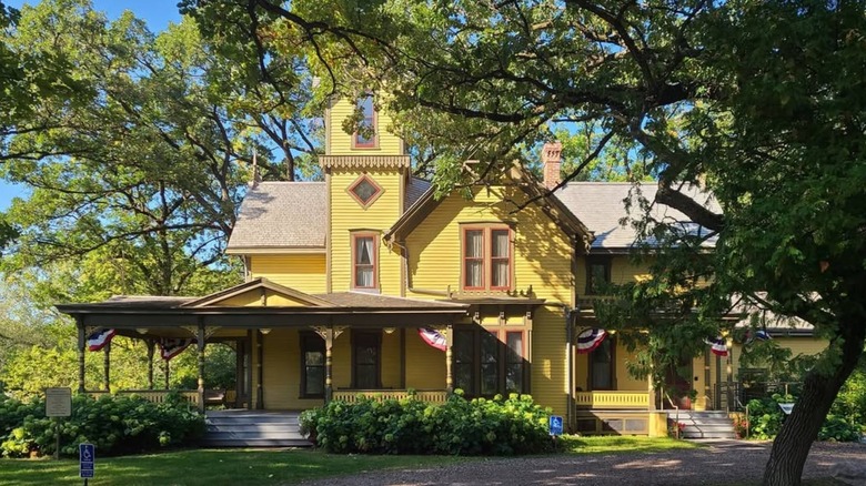 The facade of the Charles H. Burwell House, surrounded by trees