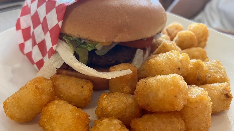A beef burger with a side of tater tots served up at Nan & Pop's Diner in Winters