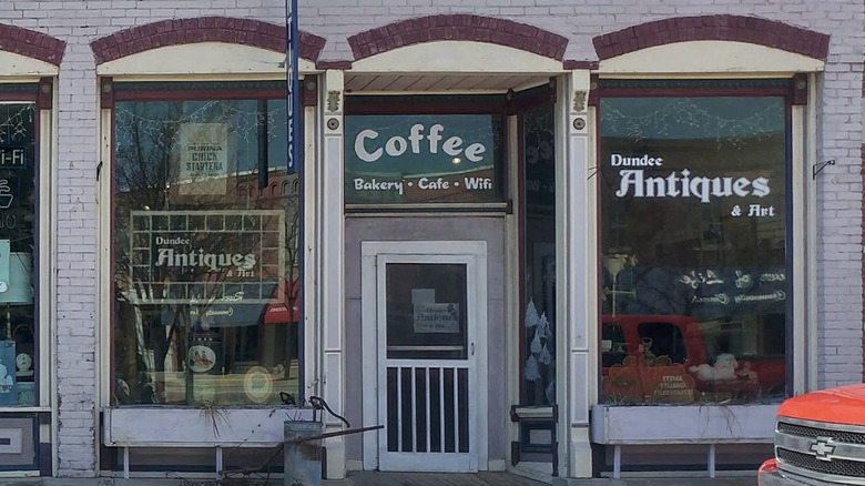 A storefront with signs reading Dundee Antiques & Art and Coffee