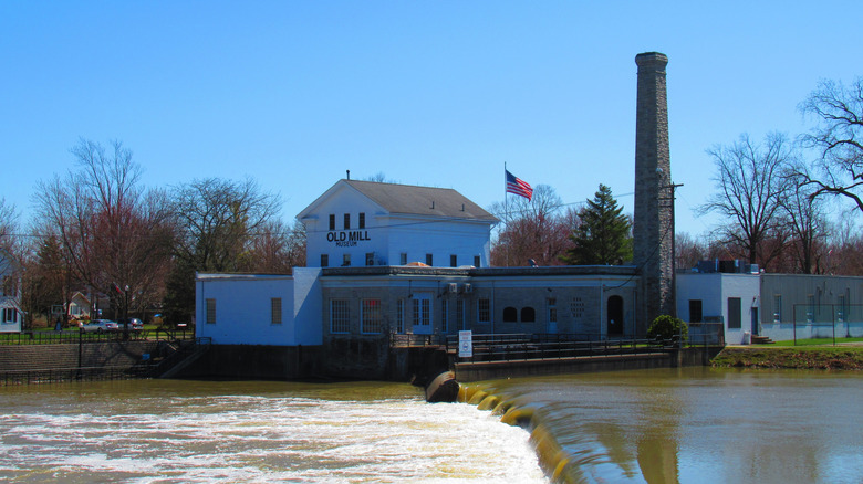 Dundee's Old Mill Museum next to a river dam