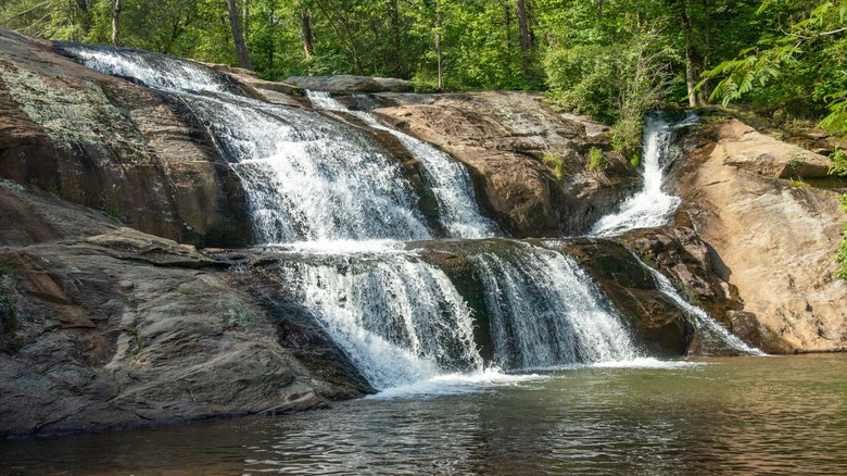 Water cascading down rocks at MacGalliard Falls in Valdese, North Carolina