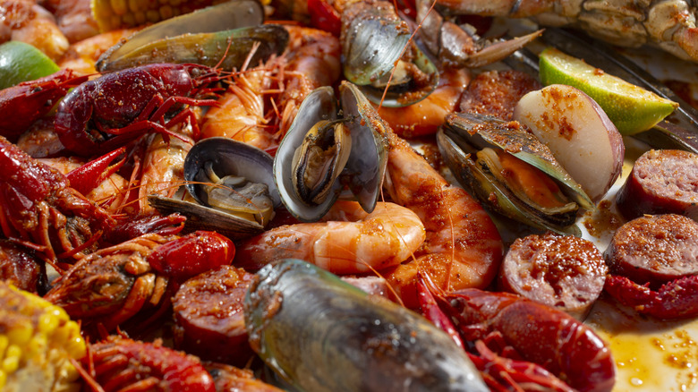 A typical seafood boil featuring mussels, shrimp, and sausage