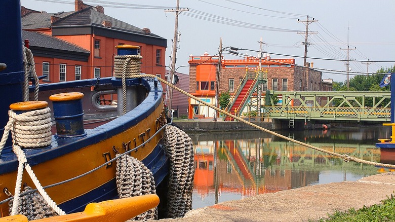 The corner of a boat on the Erie Canal with the village of Albion in the background.