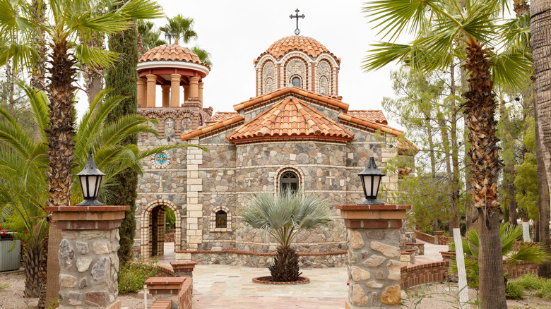 Stone chapel surrounded by desert palms