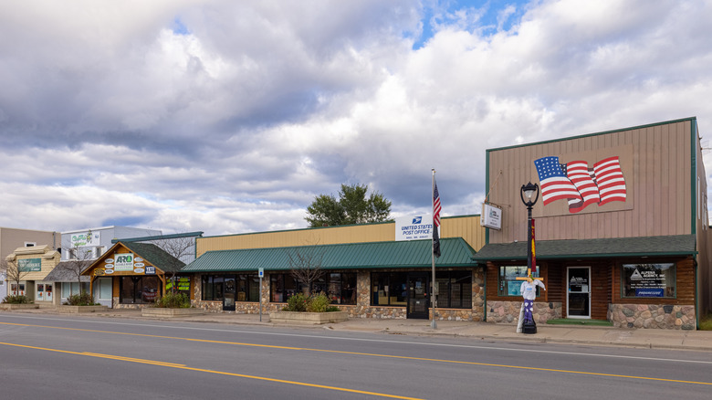 Downtown Mio with fairly plain and small one and two-story buildings, one of which has a large painted American flag