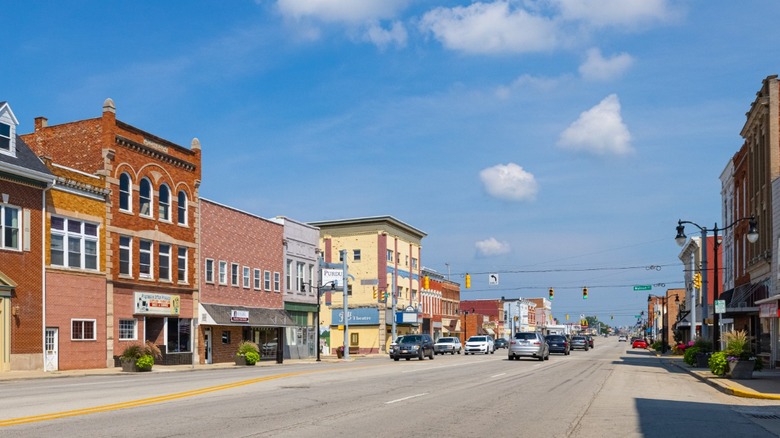 A row of historic buildings housing local shops in Portland, Indiana on a sunny day.
