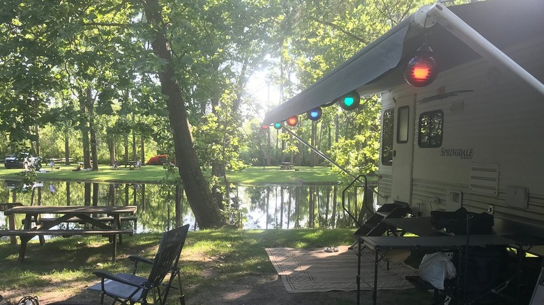 Camper parked near riverbank in campground