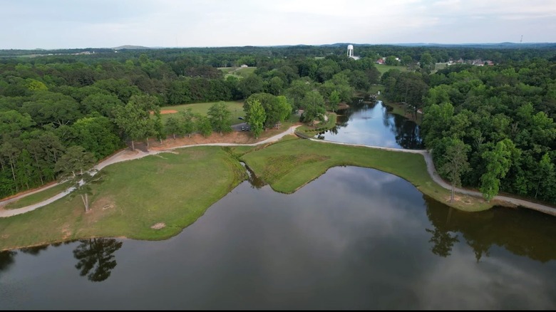 Aerial views of two lakes inside a city park in Lineville, Alabama, surrounded by dense woodlands.