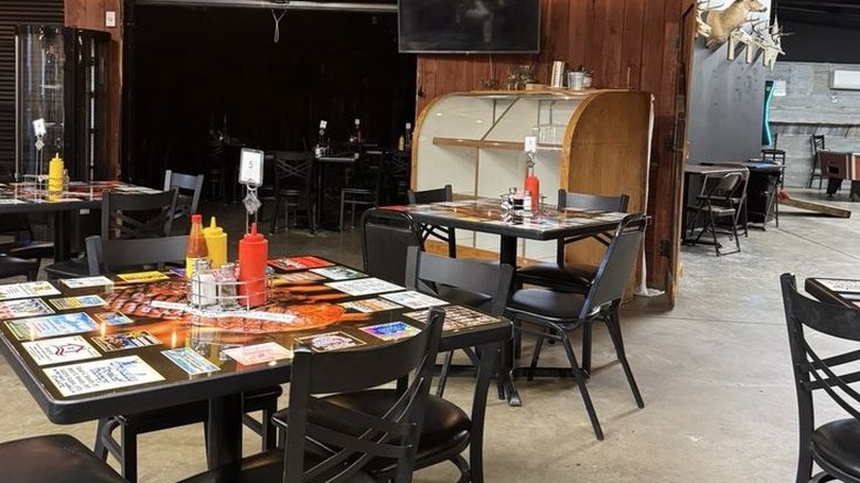 Tables and wooden walls inside Wiley's Cove Hideaway
