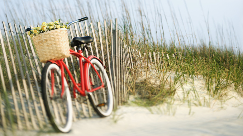 Beach cruiser leaning on a fence along Holden Beach