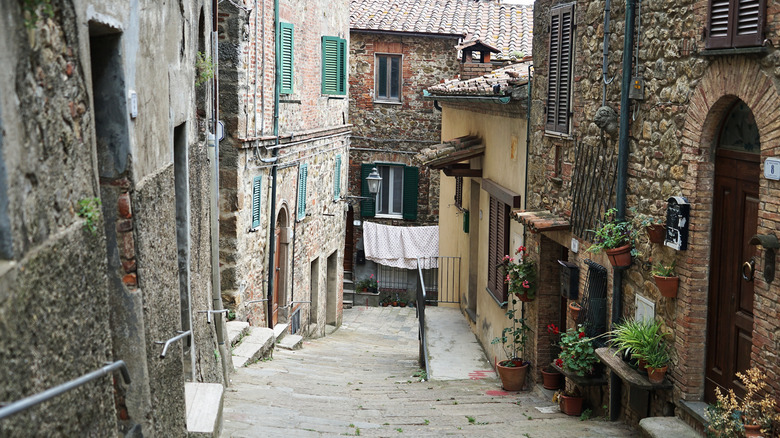 An alley surrounded by stone houses in Chiusdino, Italy
