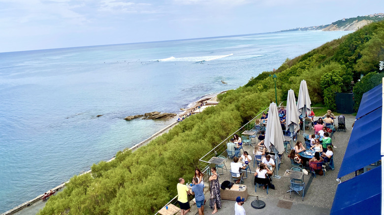 a restaurant terrace overlooking the ocean