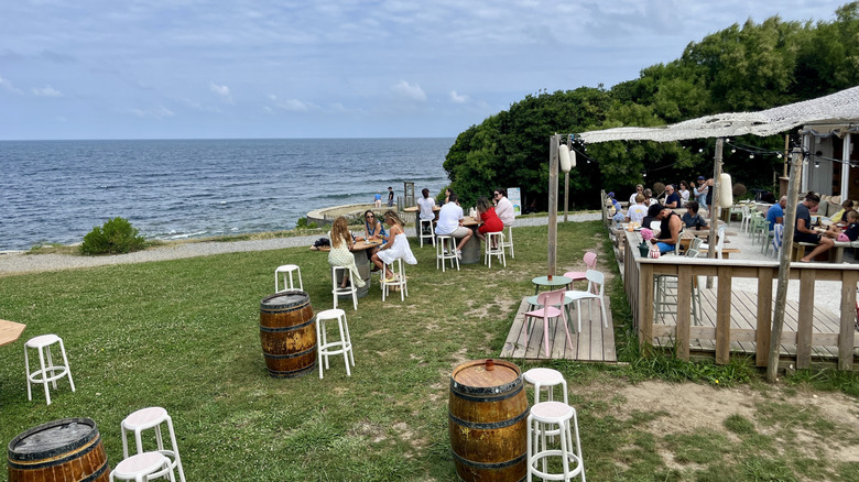 people relaxing at a beach side bar in France