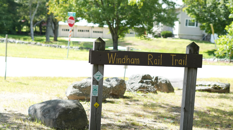 Windham Rail Trail sign close-up on summer day.