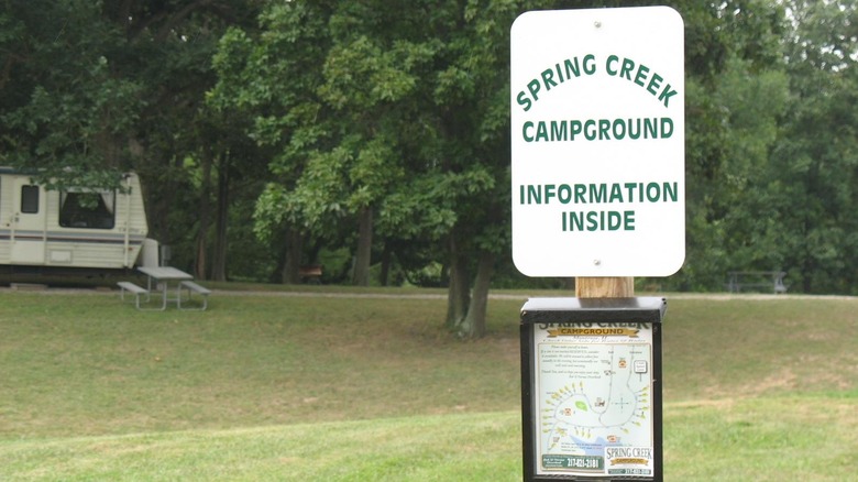 Sping Creek campground sign with an RV in the background