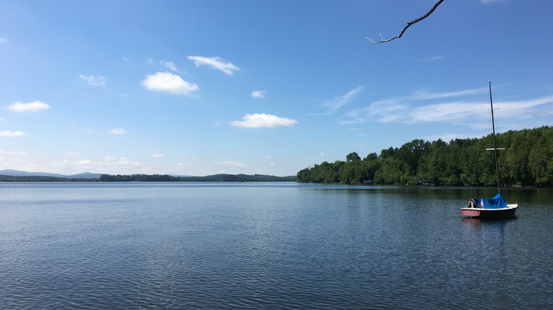 A sailboat on the calm water on Lake Carmi in Lake Carmi State Park in Franklin, Vermont