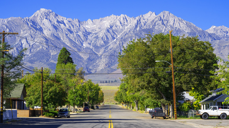 Small-town road leading to mountains