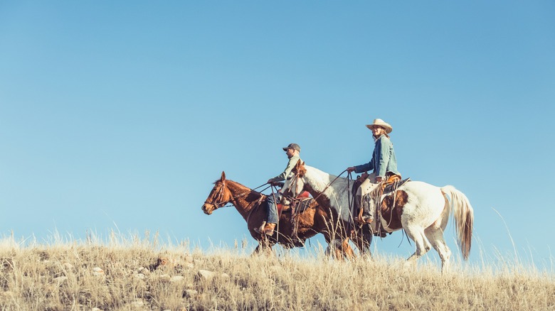 man and woman riding horses in Montana