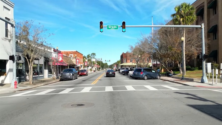 Businesses line street with blue sky overhead in Downtown Perry, Florida