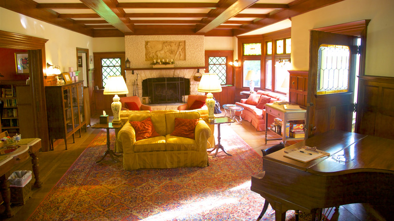 Interior of Manor House Inn with door open letting light shine in the rustic lobby area.