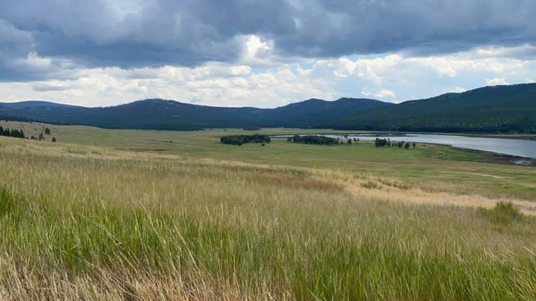 A sprawling prairie at Lost Trail National Wildlife Refuge in Montana, with storm clouds in the background