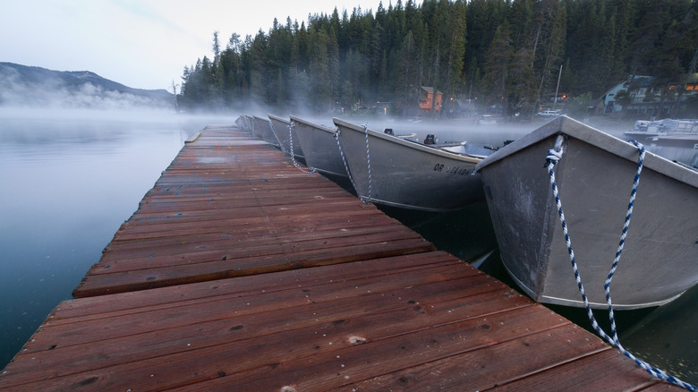 Boats resting on pier of misty Diamond Lake Resort