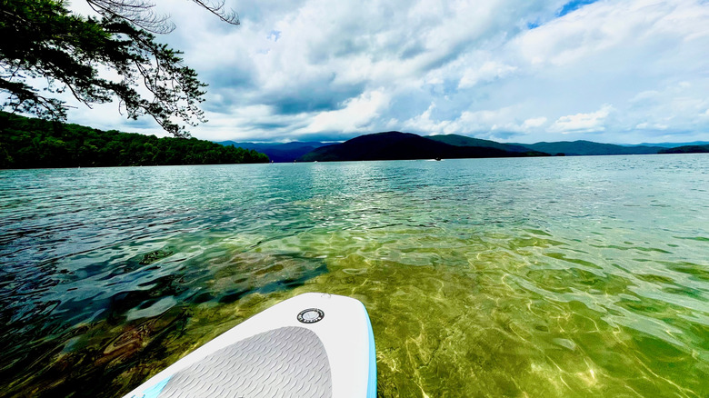 A paddleboard on Lake Jocassee with mountains surrounding