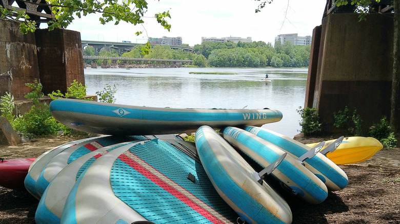 Paddleboards stacked by the bank of James River